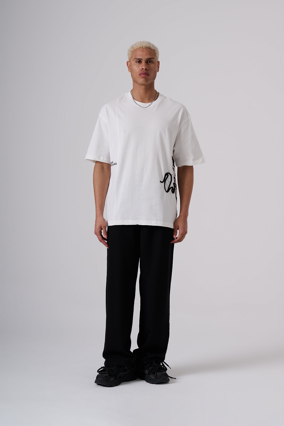 White Oversized T–Shirt – Minimal Black Embroidered Chest Detail