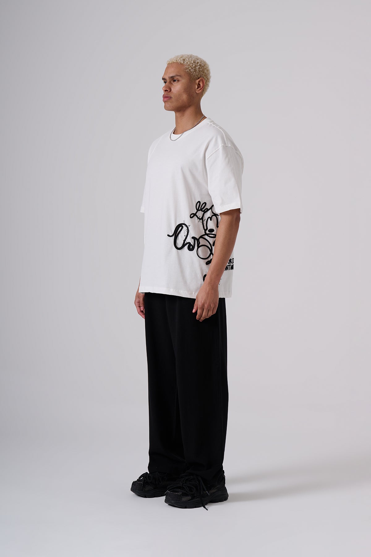 White Oversized T–Shirt – Minimal Black Embroidered Chest Detail