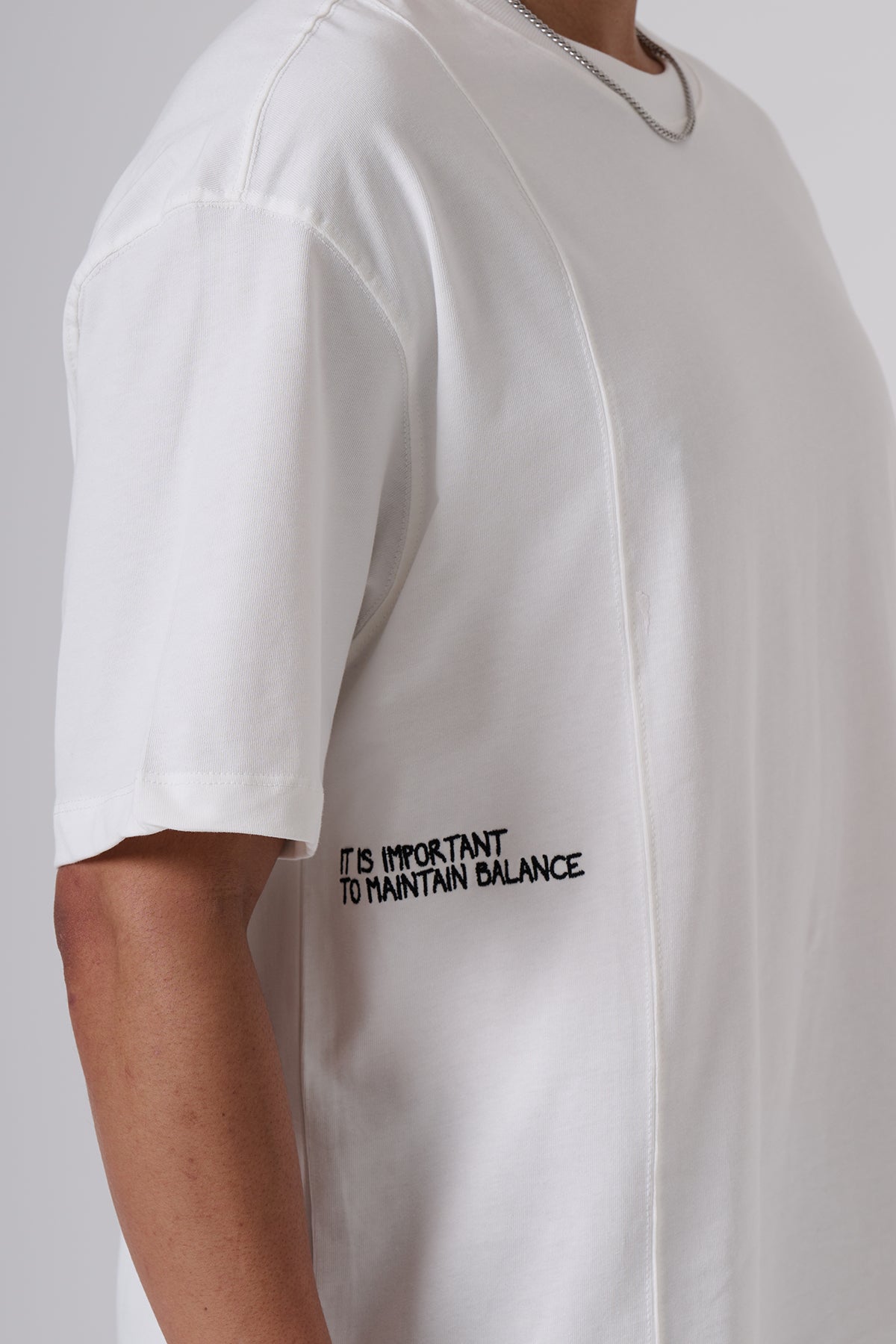 White Oversized T–Shirt – Minimal Black Embroidered Chest Detail