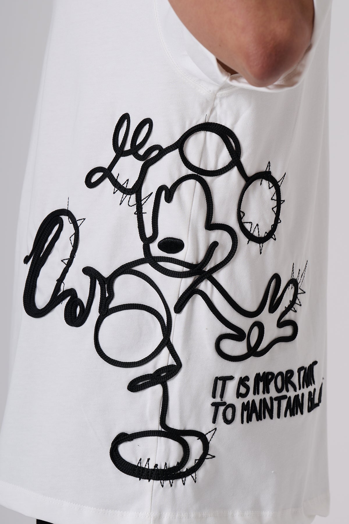 White Oversized T–Shirt – Minimal Black Embroidered Chest Detail