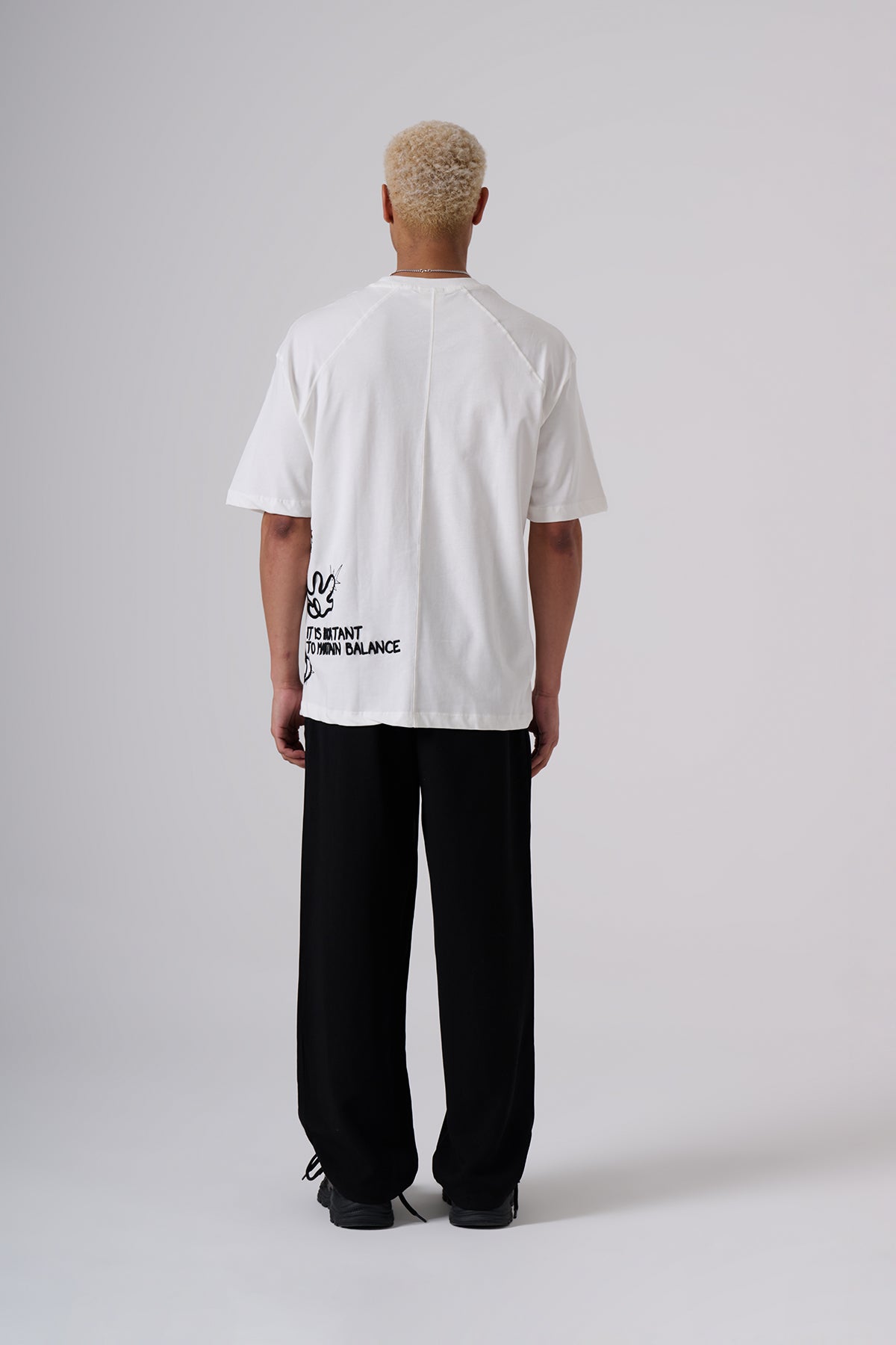 White Oversized T–Shirt – Minimal Black Embroidered Chest Detail